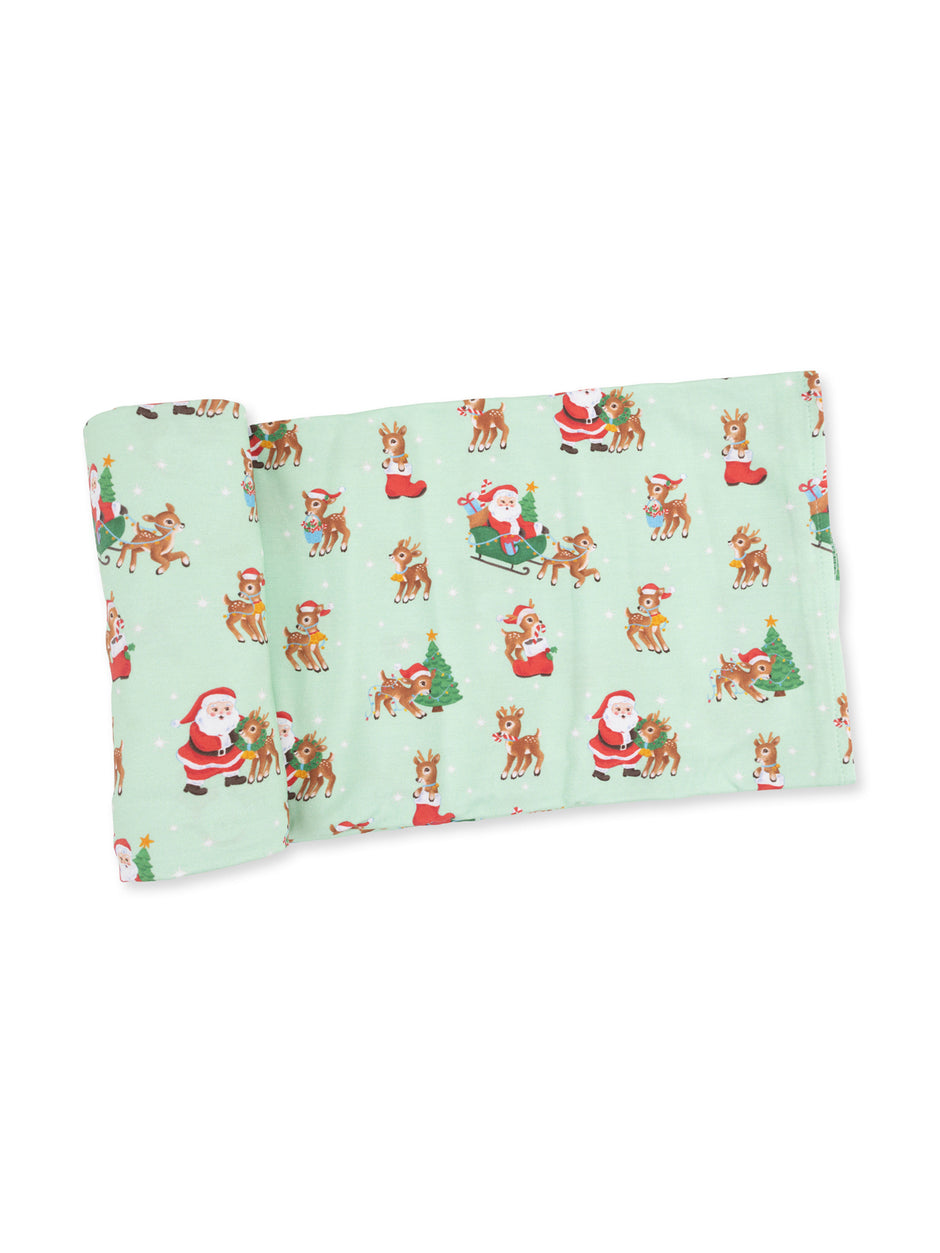 Festive mint green blanket with Santa and reindeer cartoon patterns. Perfect for holiday cheer and cozy warmth.