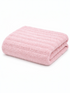 Soft pink bath towel neatly folded, featuring a textured design on a white background.