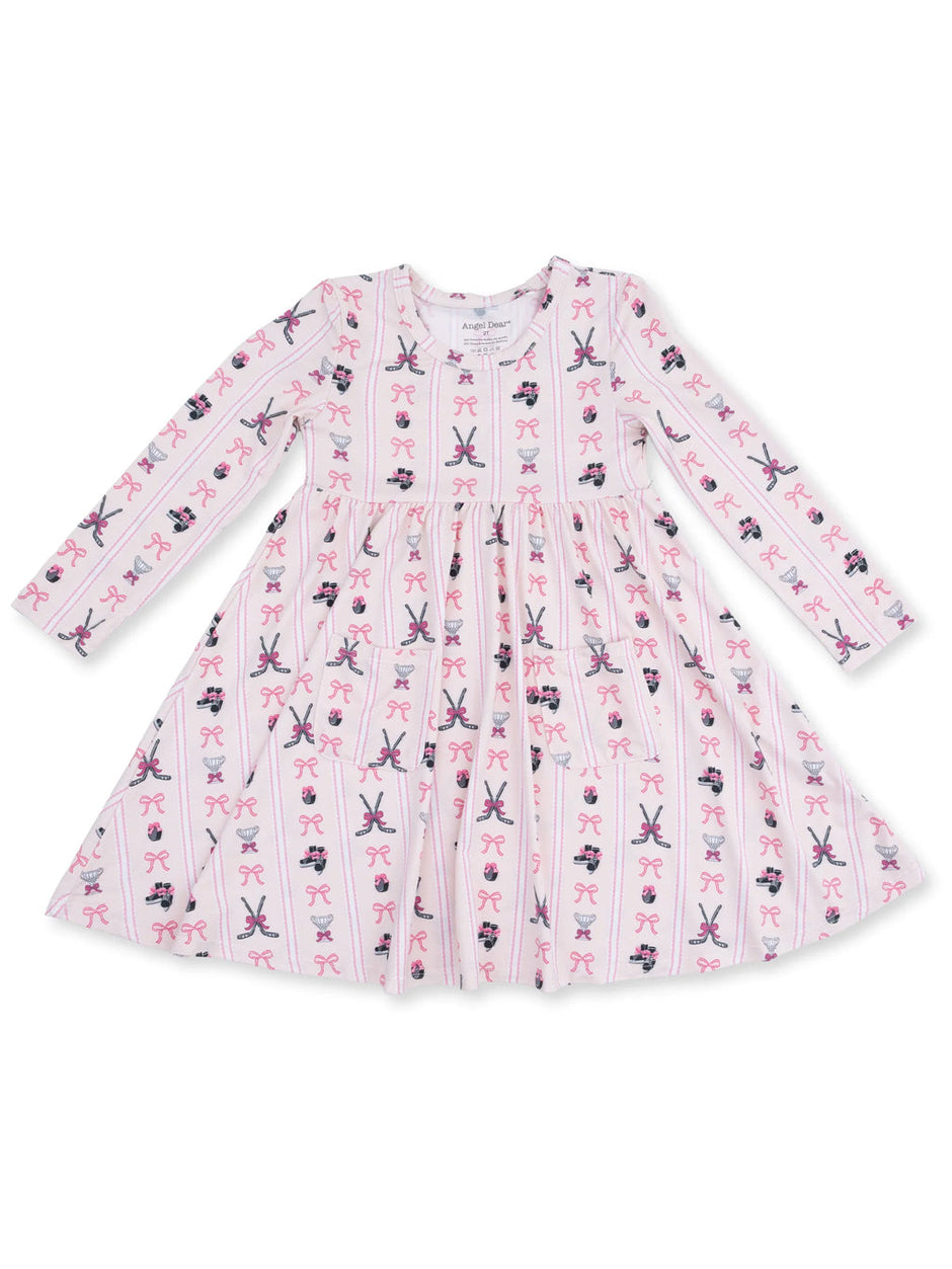 Long-sleeve pink dress with playful patterns of bows and ballet shoes, designed for children.