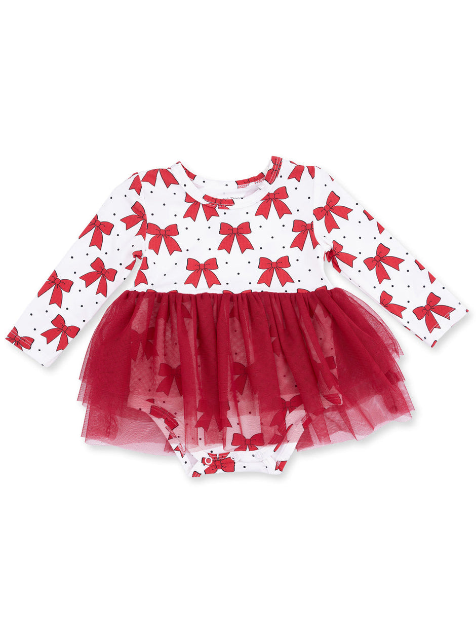 Red bow-patterned long-sleeve baby dress with a tulle skirt and polka dots on a white background.