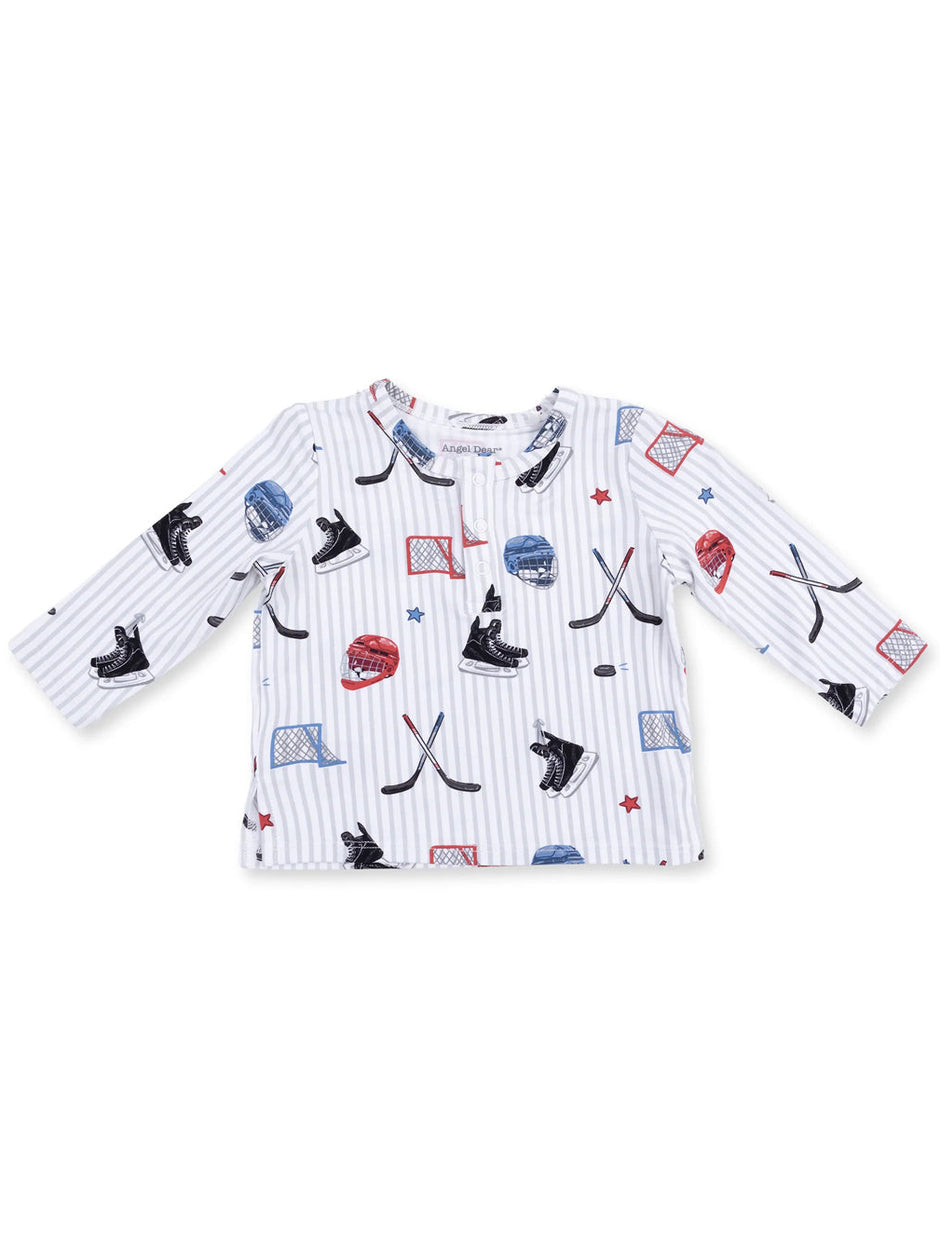 Long-sleeve kids' shirt featuring hockey graphics like skates, sticks, and goals on a striped background.