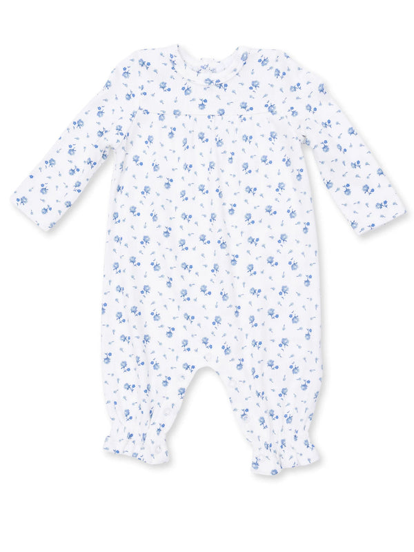 White baby romper with blue floral print and long sleeves. Soft fabric with gathered cuffs for comfort.