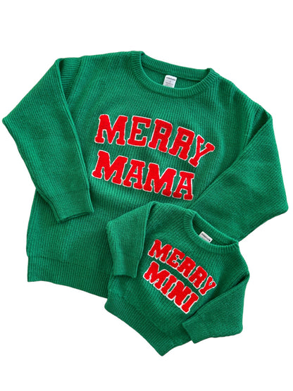 Green matching holiday sweaters for adults and kids, featuring "MERRY MAMA" and "MERRY MINI" in red letters.