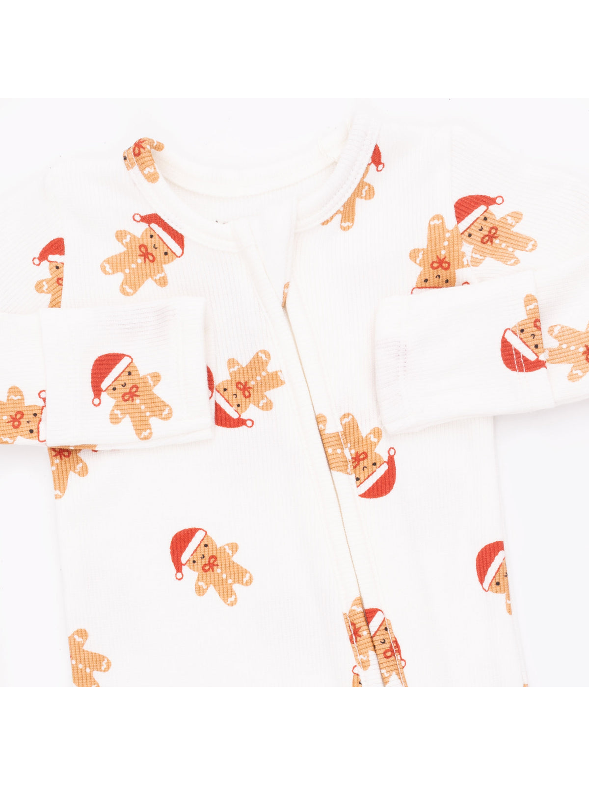 White baby onesie with gingerbread men wearing Santa hats. Cheerful holiday-themed design.