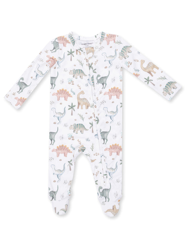 White baby onesie with colorful dinosaur and plant patterns, featuring long sleeves and a front zipper.