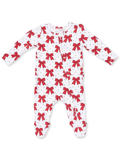 White baby onesie with red bows and black polka dots, featuring long sleeves and a front zipper.