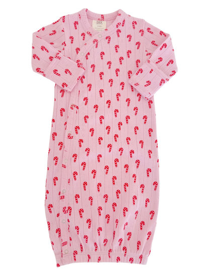 Pink baby gown with red candy cane pattern, featuring long sleeves and elastic bottom for easy dressing.