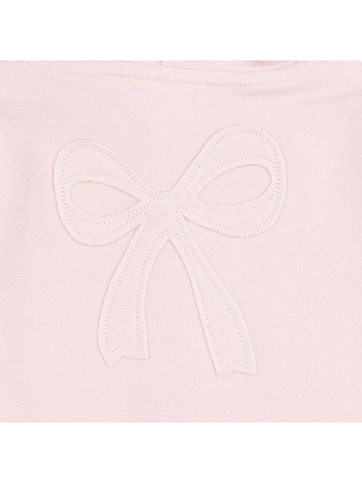 Embroidered pink fabric with a white bow design at the center.