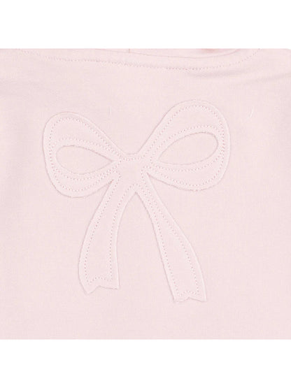 Embroidered pink fabric with a white bow design at the center.