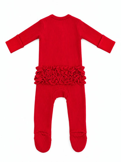 Red ribbed baby onesie with ruffle details at the waist, featuring long sleeves and footed legs.