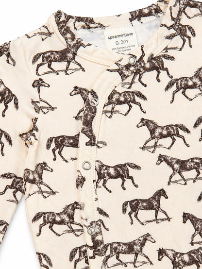 Bamboo viscose baby outfit featuring a playful horse print, with snap buttons and a soft cream background.