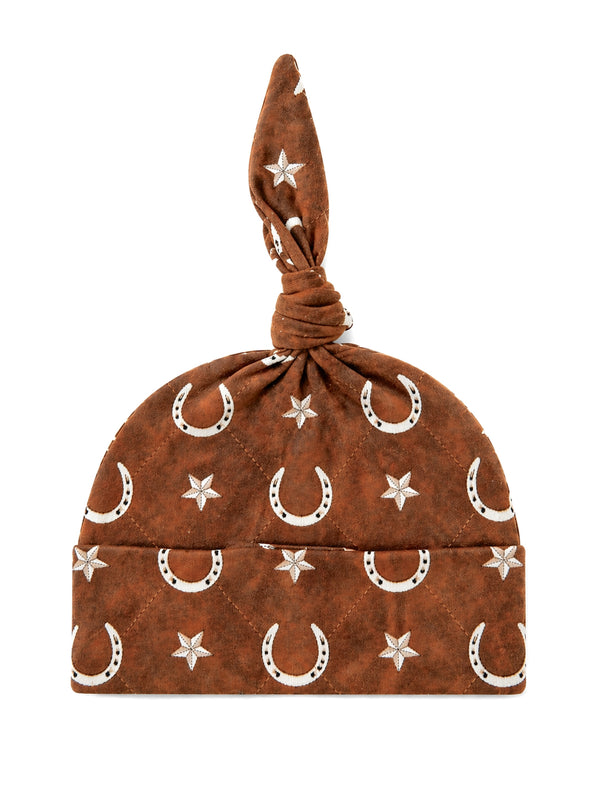 Brown hat with star and horseshoe patterns, featuring a knotted top for a stylish look.