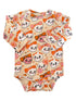 Long-sleeve baby onesie with a playful skull and bow pattern in pastel colors against a cream background.