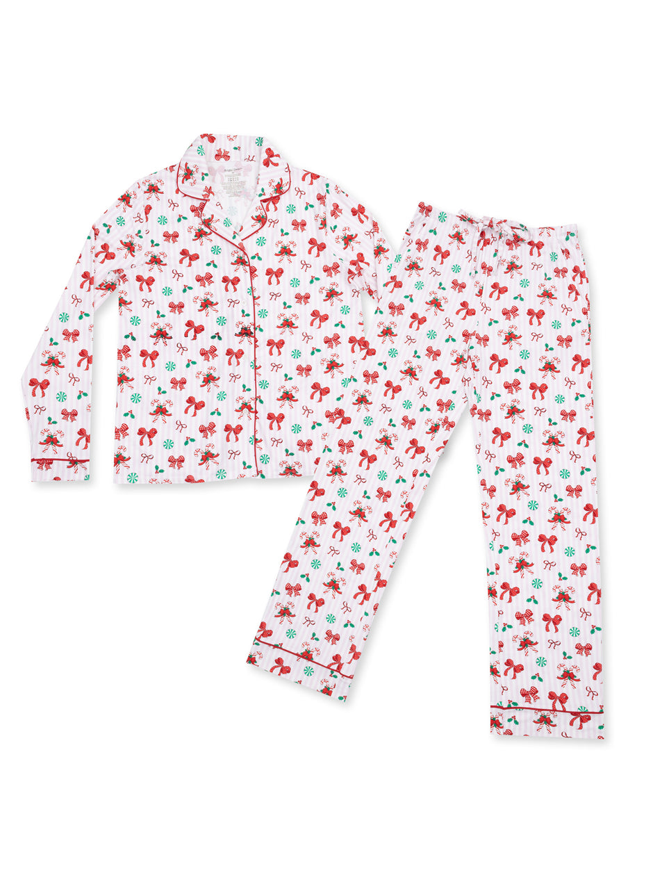 Red and green festive pajama set with bows and holiday motifs, featuring a button-up top and elastic-waist pants.