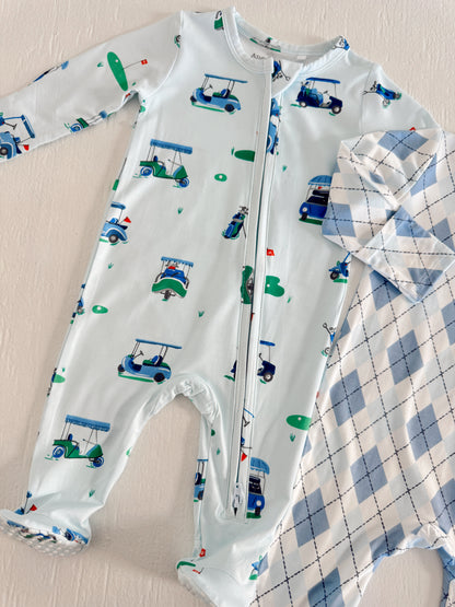 Light blue baby onesie with golf cart pattern alongside a diamond-patterned shirt in soft blue tones.