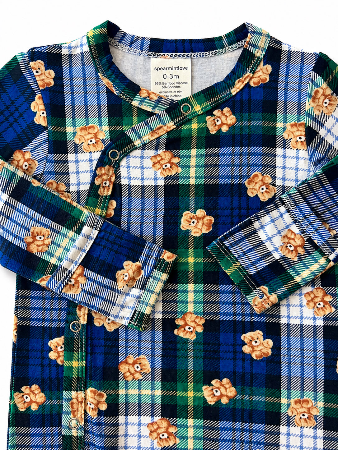 Blue plaid baby onesie featuring teddy bear motifs and snap closures. Suitable for newborns.