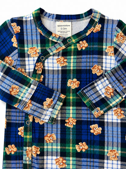 Blue plaid baby onesie featuring teddy bear motifs and snap closures. Suitable for newborns.