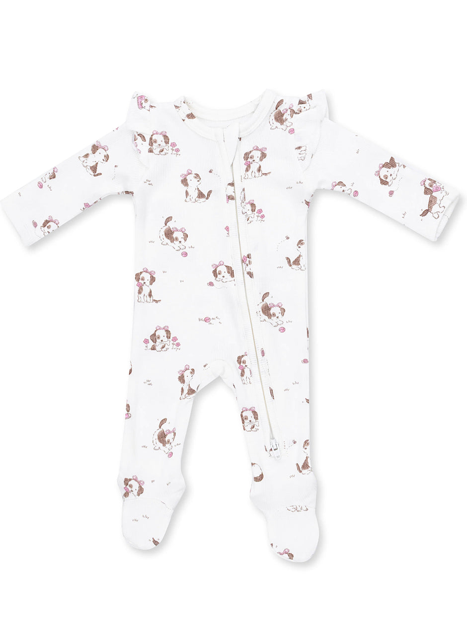 White baby onesie with a cute dog print and floral accents, featuring a front zipper and long sleeves.