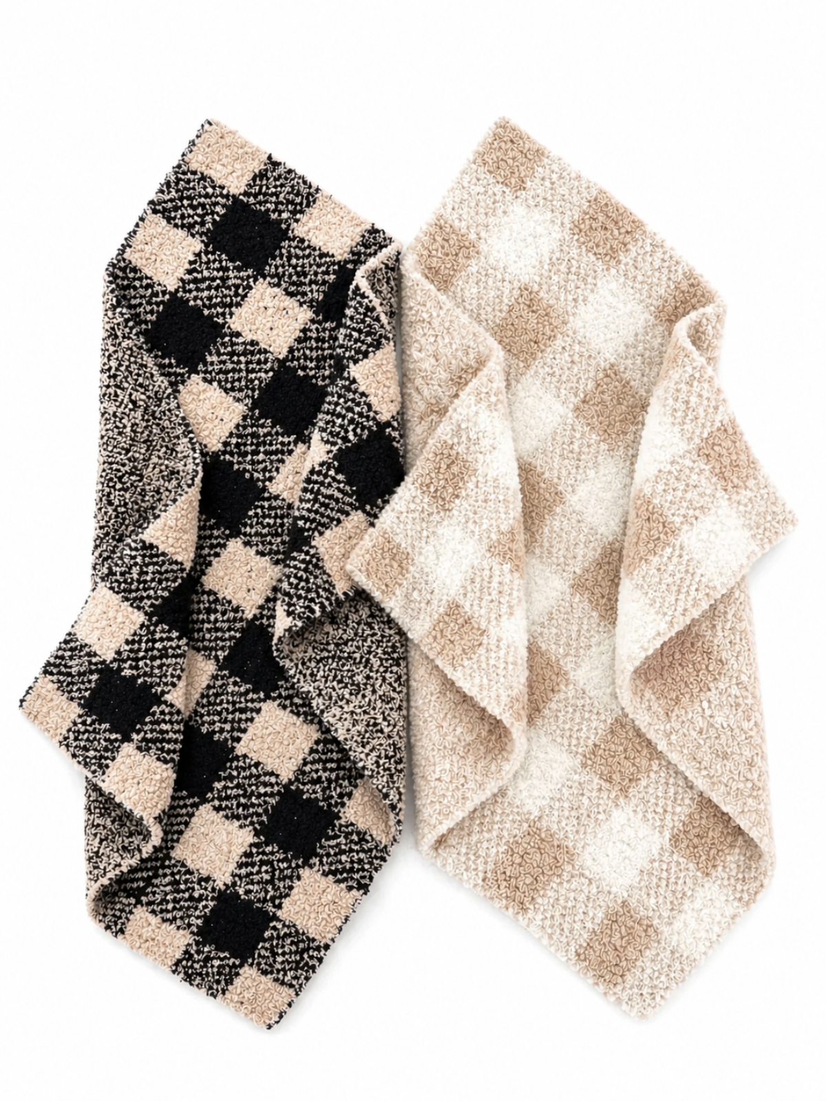 Two checkered blankets, one in black and beige, the other in cream and tan, layered together.