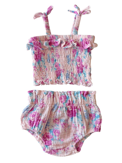 Floral patterned toddler swimsuit set with ruffled top and matching bottoms in pink, blue, and lavender hues.