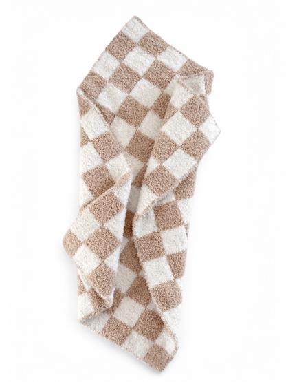 Brown and white checkered towel draped elegantly on a white background.
