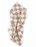 Brown and white checkered towel draped elegantly on a white background.