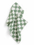 Green and white checkered towel draped, featuring a soft, textured fabric. Ideal for kitchen or bathroom use.