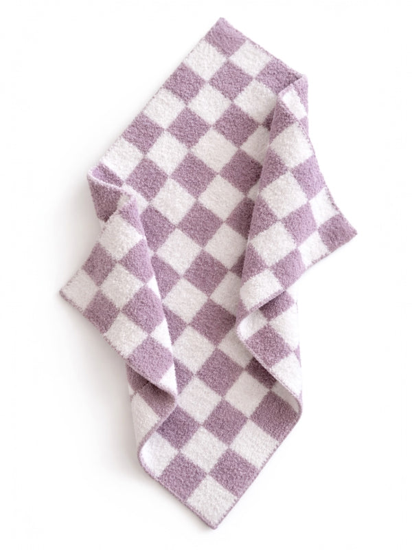 Purple and white checkered fabric draped on a flat surface, showcasing its soft texture and pattern.