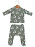 Green baby outfit with long-sleeve top and pants, featuring white tree patterns on a textured fabric.