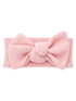 Light pink headband with a large bow and textured fabric. Perfect for styling hair and adding a cute touch.
