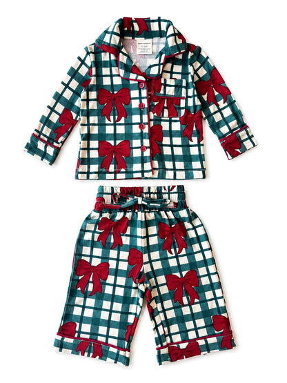 Green and white checkered pajama set featuring red bows, consisting of a long-sleeve top and shorts.