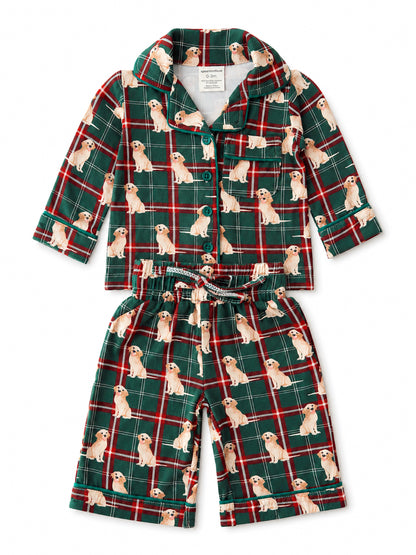 Green plaid pajama set featuring playful golden retriever illustrations on the fabric.