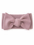 Light pink ribbed headband with a large bow detail, displayed on a white background.