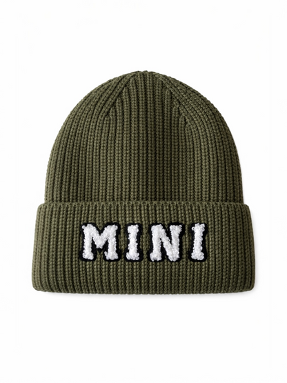 Olive green knit beanie hat with the word "MINI" embroidered on the front.