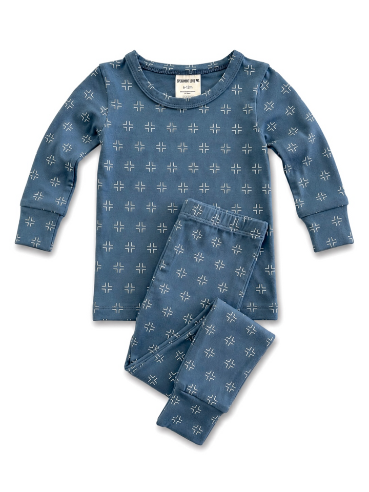 Blue patterned children's pajamas with long sleeves and pants, featuring a modern geometric design.