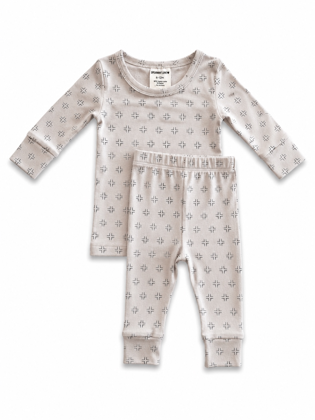 Beige long-sleeve pajama set with black geometric patterns for infants. Includes top and matching pants.