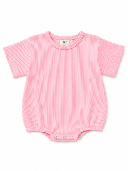 Pink ribbed baby bodysuit with short sleeves and snap closures at the bottom.