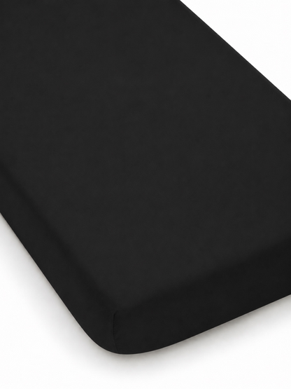 Black fitted mattress cover on a white background, showcasing soft texture and sleek design.