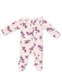 Pink floral baby onesie with ruffled shoulders and footed design, featuring small blue and red flowers.