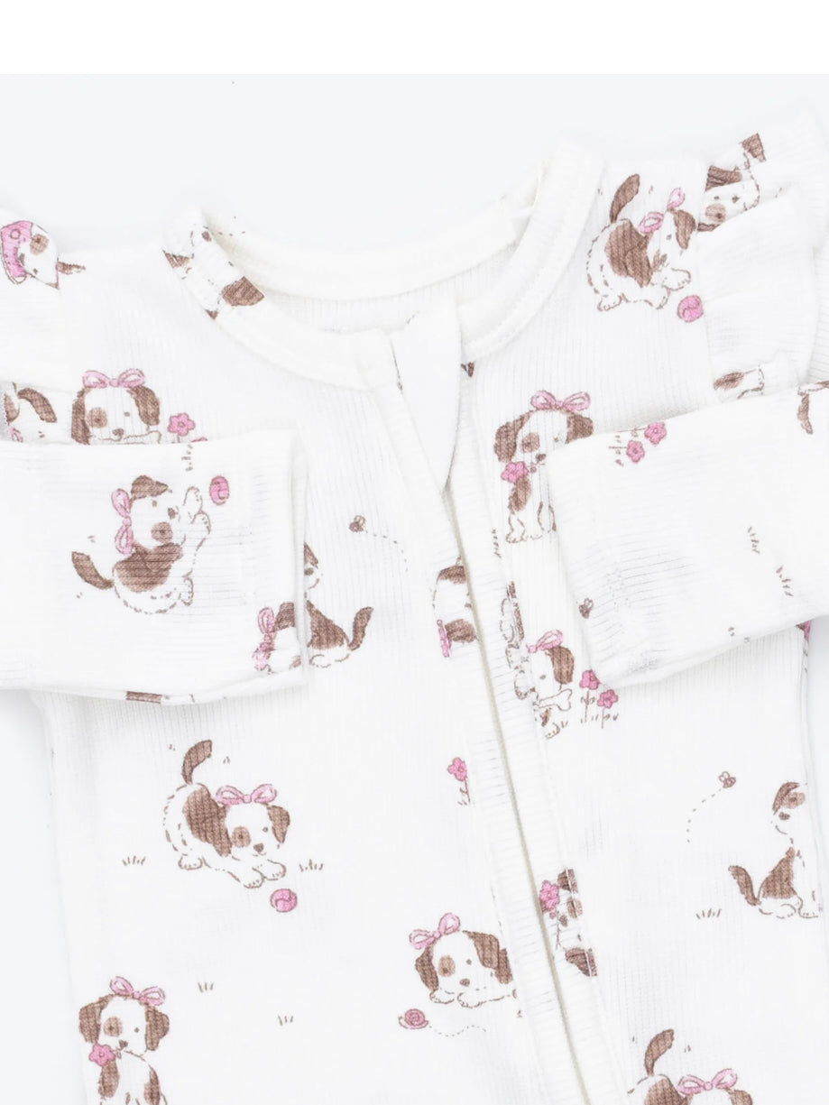 White baby onesie with a playful dog print and pink accents, featuring long sleeves and a front zipper closure.