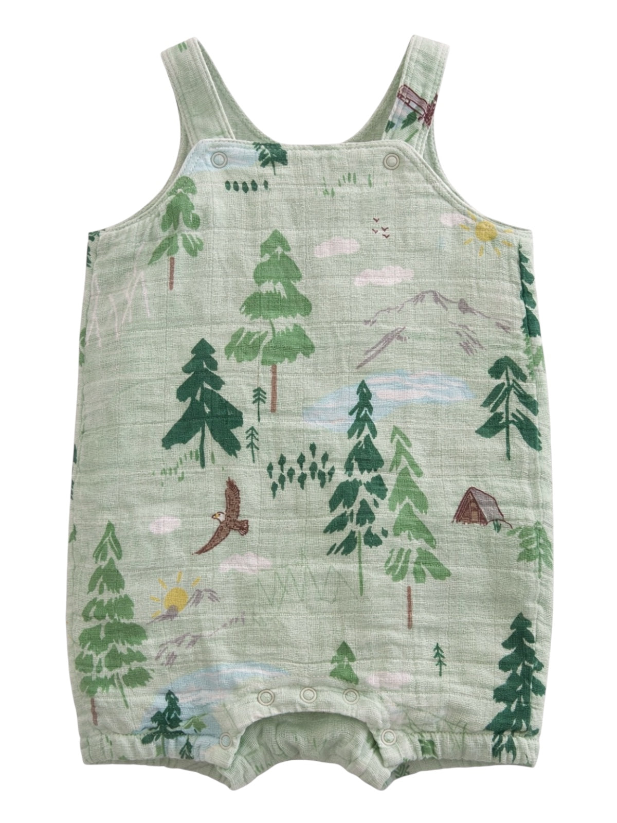Light green baby romper with forest and mountain scene, featuring trees, animals, clouds, and a sun.