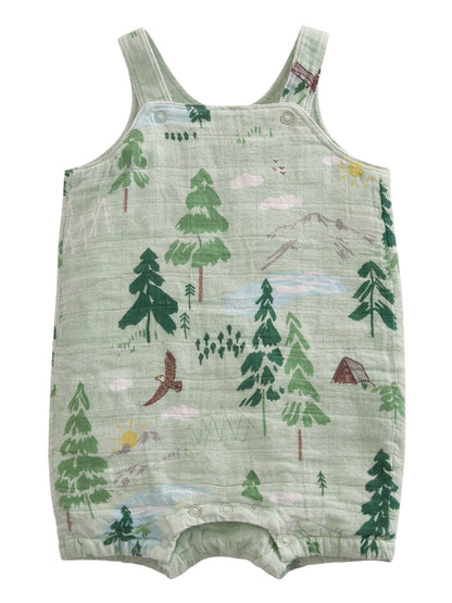 Light green baby romper with forest and mountain scene, featuring trees, animals, clouds, and a sun.
