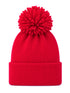 Red knit beanie with a large pom-pom on top, featuring a folded cuff for warmth and style.