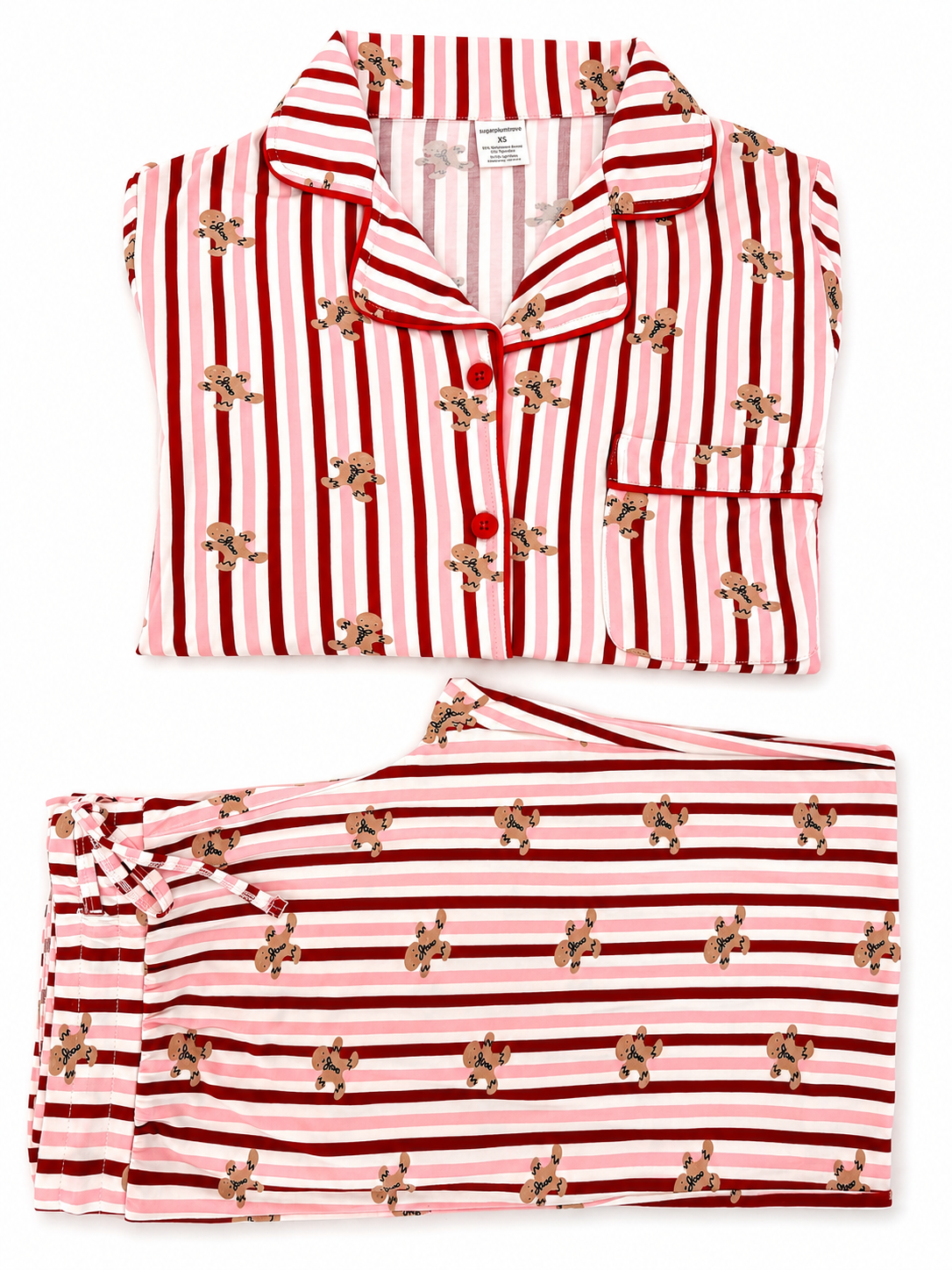 Red and pink striped women's pajamas with gingerbread cookie print, neatly folded.
