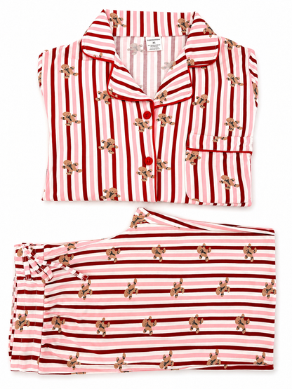 Red and pink striped women's pajamas with gingerbread cookie print, neatly folded.