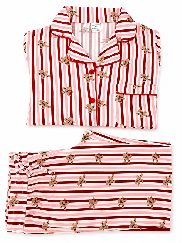 Red and pink striped women's pajamas with gingerbread cookie print, neatly folded.