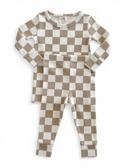 Tan and white checkered children's pajama set, featuring a long-sleeve top and matching pants.