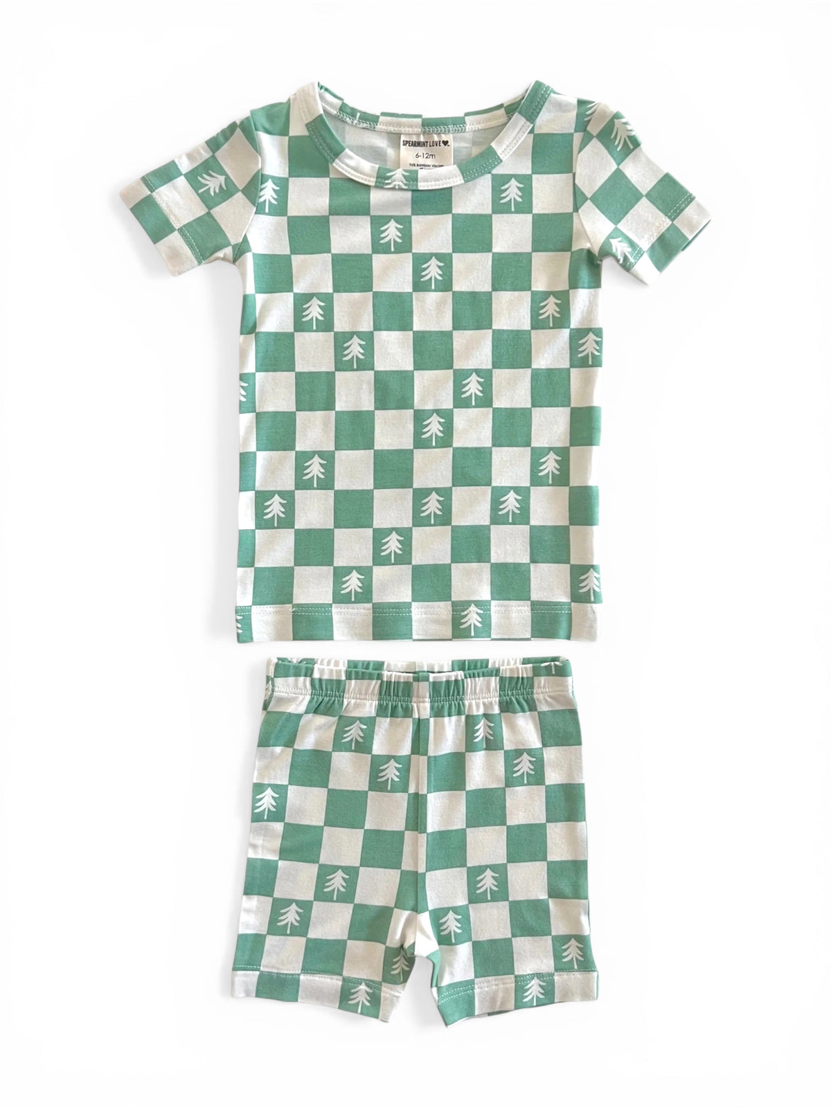 Green and white checkered children's pajamas featuring tree patterns, consisting of a short-sleeve top and shorts.