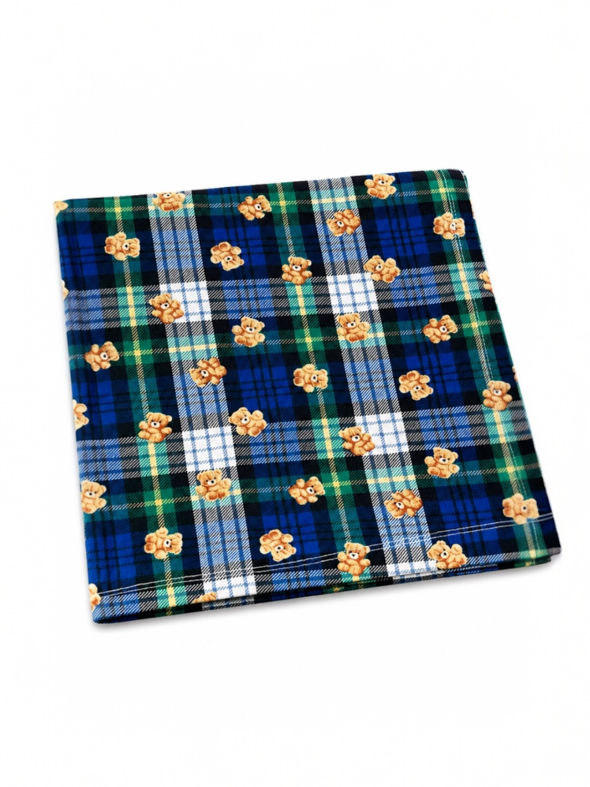 Colorful plaid fabric featuring teddy bear illustrations on a blue and green background.