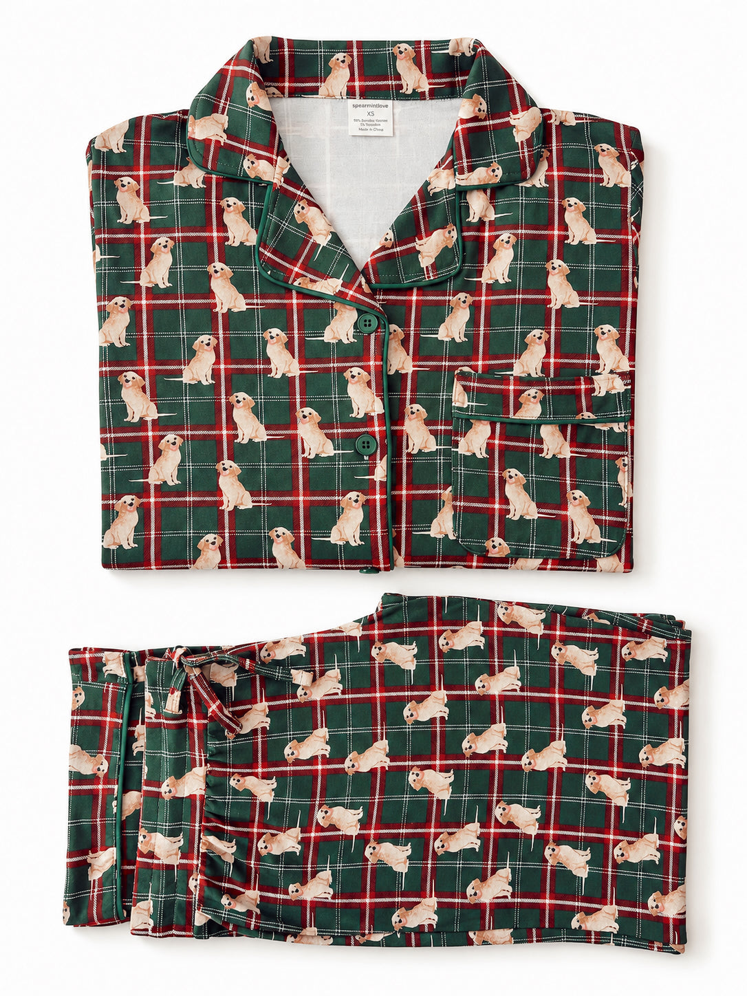 Green plaid pajamas featuring playful dog prints, neatly folded and displayed.